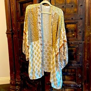 Featured in a maxi-style floral design w/long billowy sleeves.